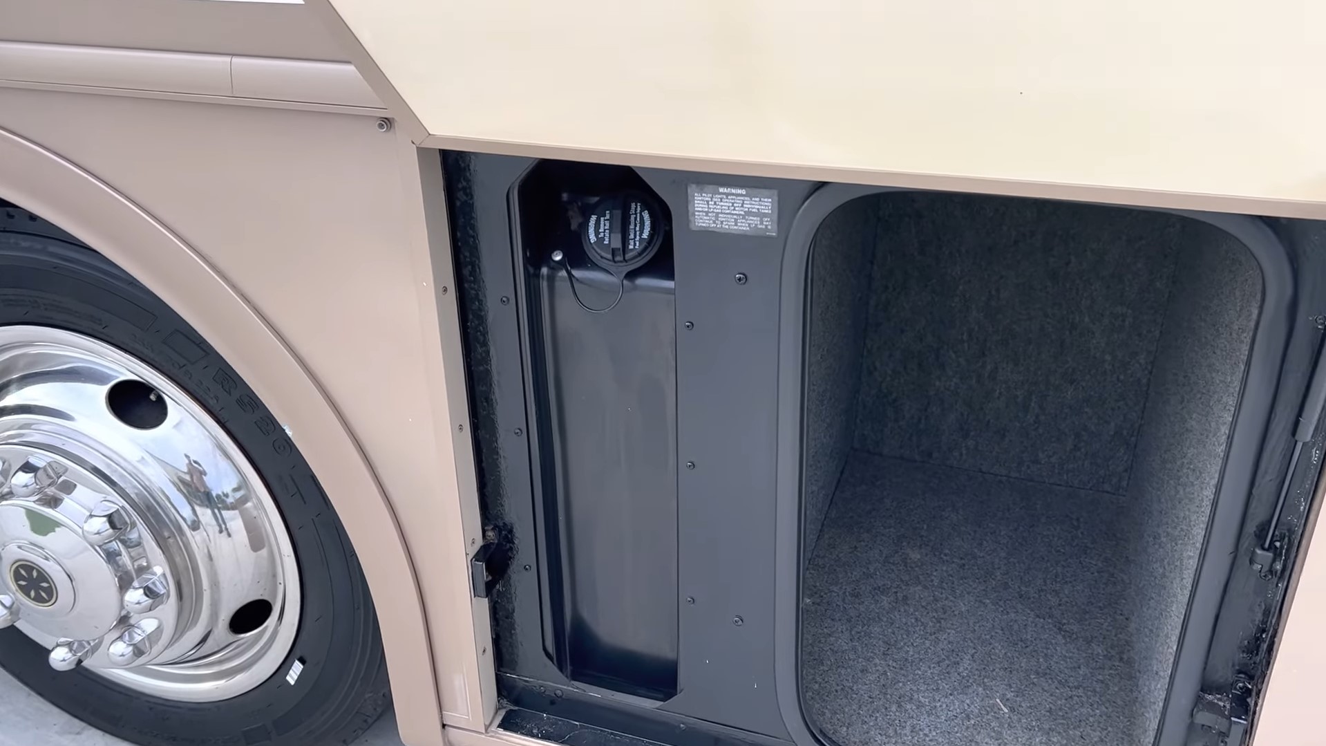 2000 Fleetwood Bounder 39Z — open pass-through storage bay and polished wheel